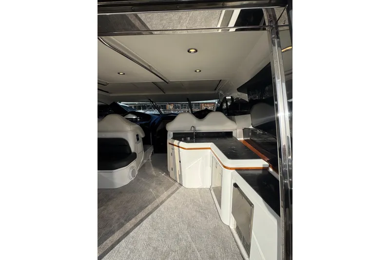Slide: The Image of Interior of 2004 Sunseeker Predator 68 yacht with modern seating and sleek design. - 28