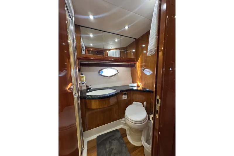 Slide: The Image of Luxurious bathroom in 2004 Sunseeker Predator 68 yacht with wood accents and modern fixtures. - 29