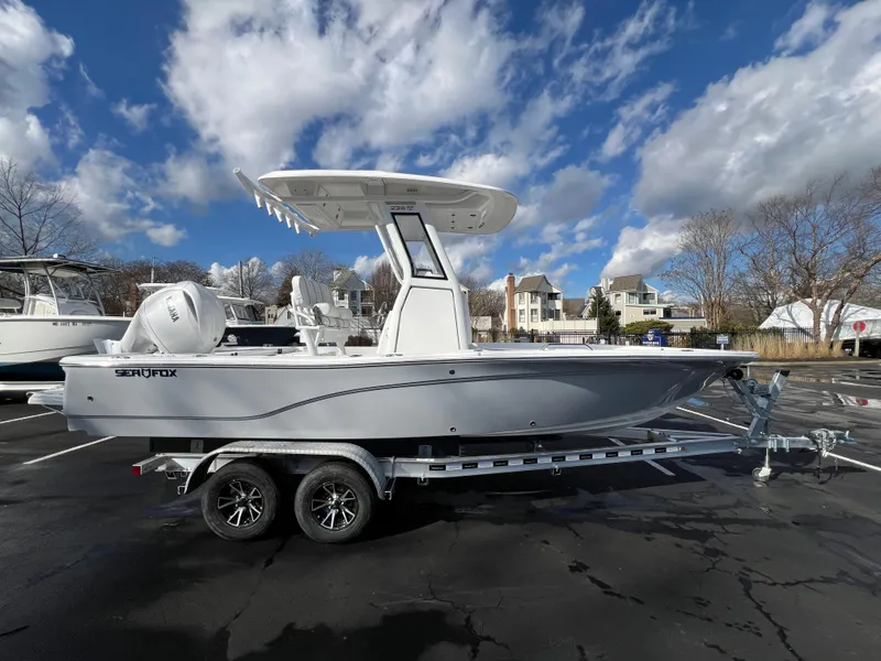 The Image of 2024 Sea Fox 231 Bay Fox boat on trailer under blue sky with clouds. - 10