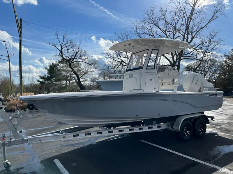 Slide: The Image of 2024 Sea Fox 231 Bay Fox boat on trailer in parking lot. - 13