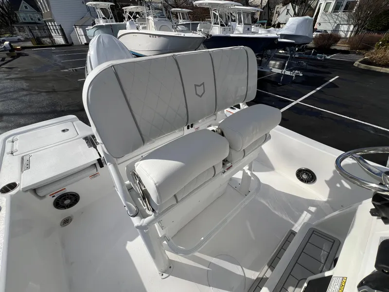 Slide: The Image of 2024 Sea Fox 231 Bay Fox boat interior with white cushioned seating. - 18