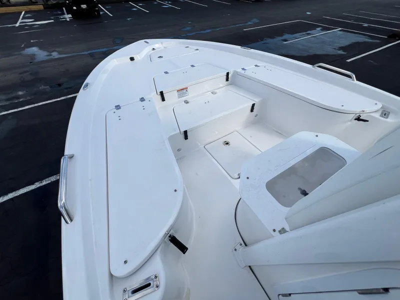Slide: The Image of 2024 Sea Fox 231 Bay Fox boat interior with storage compartments in a parking lot. - 22
