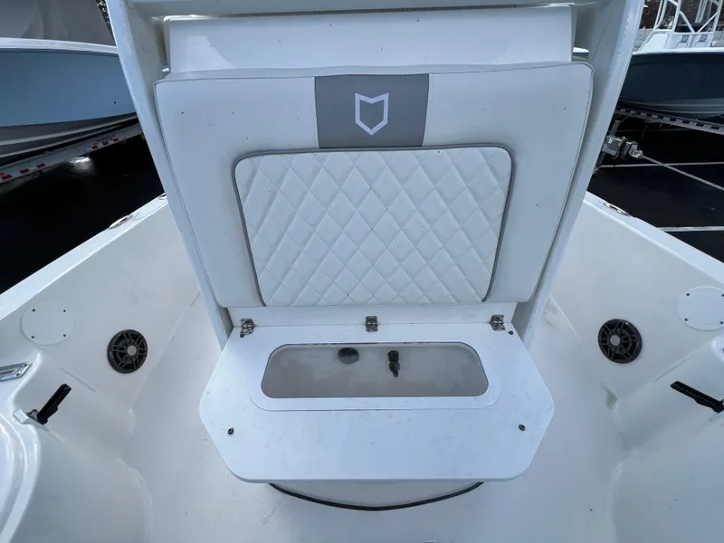 Slide: The Image of 2024 Sea Fox 231 Bay Fox boat interior with cushioned seating and storage compartment. - 25
