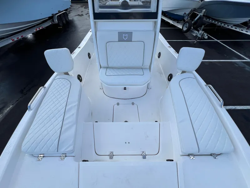 Slide: The Image of 2024 Sea Fox 231 Bay Fox boat interior with white cushioned seating. - 31