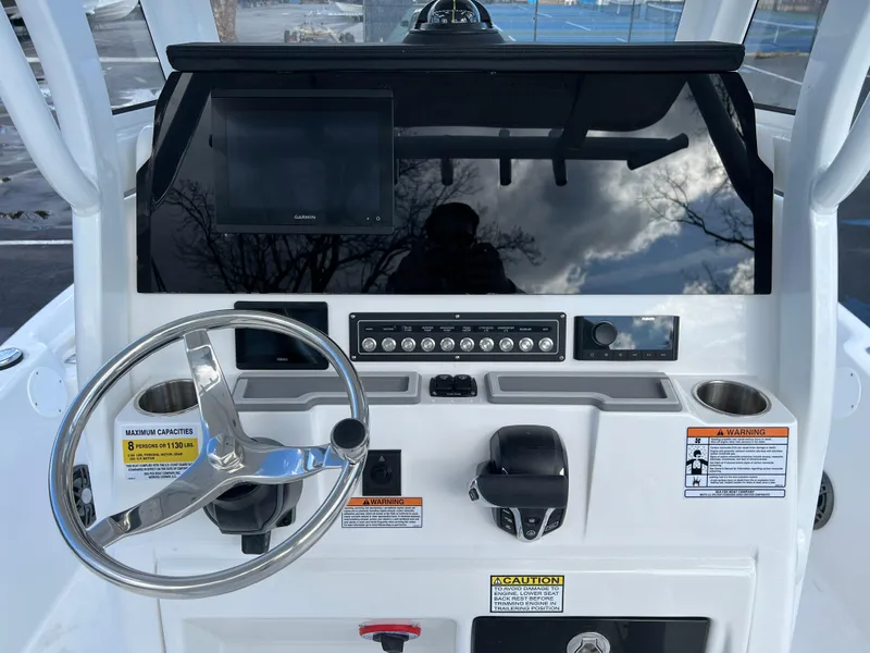 Slide: The Image of 2024 Sea Fox 231 Bay Fox boat console with steering wheel and control panel. - 32