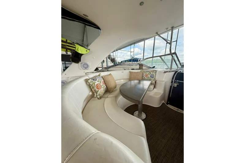 Slide: The Image of Luxurious interior of 2006 Regal Commodore 4060 yacht with plush seating and elegant table. - 10