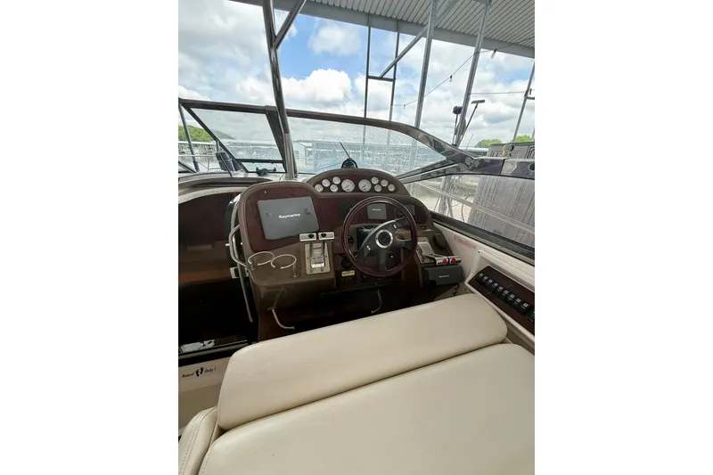Slide: The Image of 2006 Regal Commodore 4060 boat cockpit with steering wheel and navigation equipment. - 11