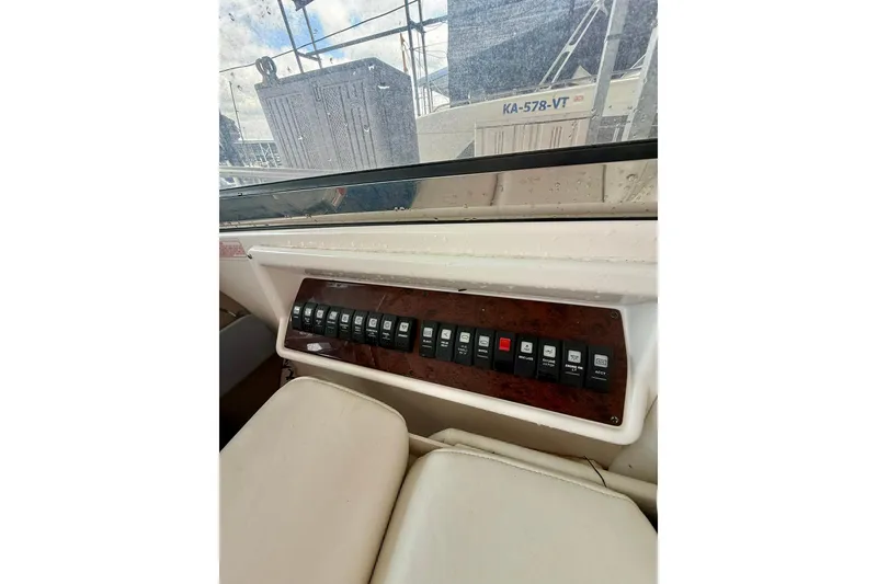 Slide: The Image of Control panel of a 2006 Regal Commodore 4060 boat with multiple switches. - 12