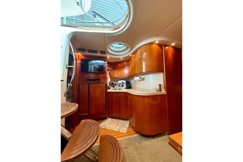 Slide: The Image of Luxurious interior of 2006 Regal Commodore 4060 yacht with wood cabinetry and modern amenities. - 16