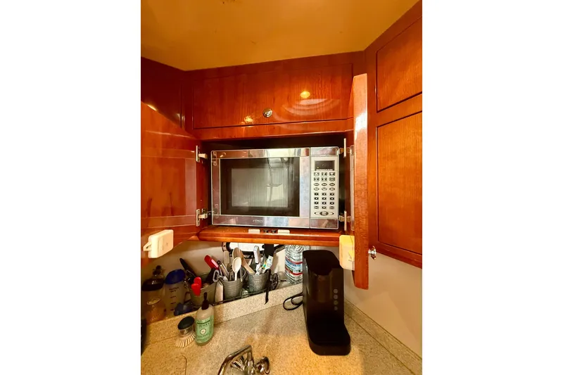 Slide: The Image of Microwave in wooden cabinet on 2006 Regal Commodore 4060 yacht kitchen. - 18