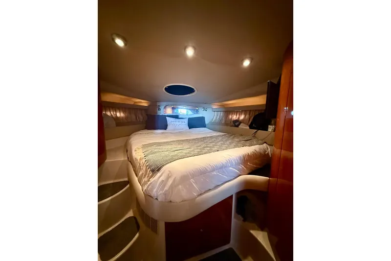 Slide: The Image of Luxurious cabin interior of 2006 Regal Commodore 4060 yacht with cozy bed and ambient lighting. - 22