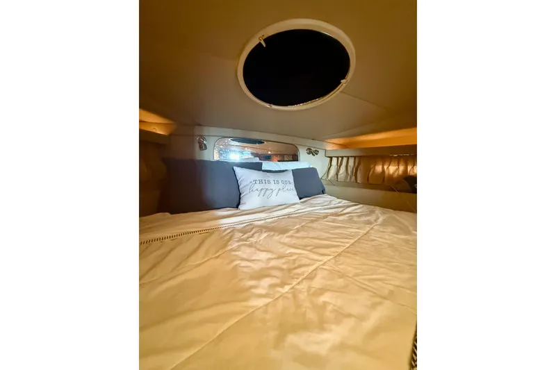 Slide: The Image of Cozy cabin interior of 2006 Regal Commodore 4060 yacht with bed and porthole. - 24