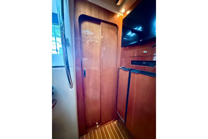 Slide: The Image of Interior of 2006 Regal Commodore 4060 yacht with wooden door and modern amenities. - 27