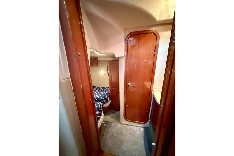 Slide: The Image of Interior of 2006 Regal Commodore 4060 yacht with wooden door and cozy cabin. - 28