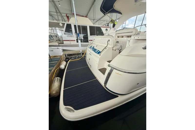 Slide: The Image of 2006 Regal Commodore 4060 yacht docked in a marina, showcasing sleek design and spacious deck. - 4