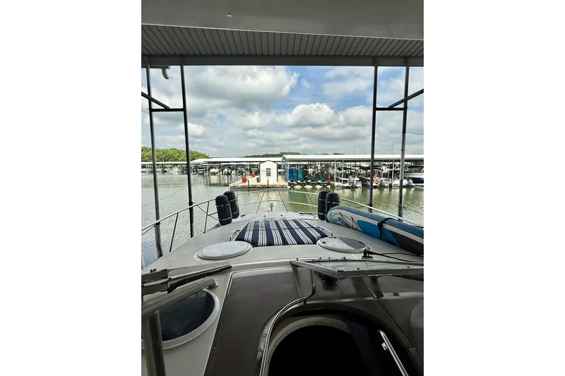 Slide: The Image of 2006 Regal Commodore 4060 yacht docked at marina under cloudy sky. - 6