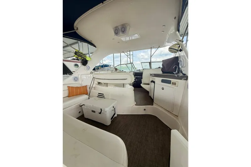 Slide: The Image of Interior of 2006 Regal Commodore 4060 yacht with seating and kitchenette. - 8