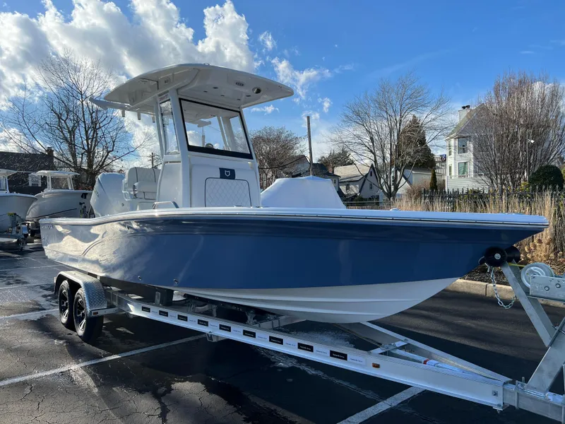 Slide: The Image of 2024 Sea Fox 251 Bay Fox boat on trailer under blue sky. - 1