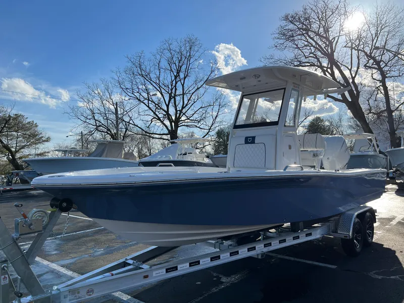 Slide: The Image of 2024 Sea Fox 251 Bay Fox boat on trailer, parked outdoors under clear sky. - 5