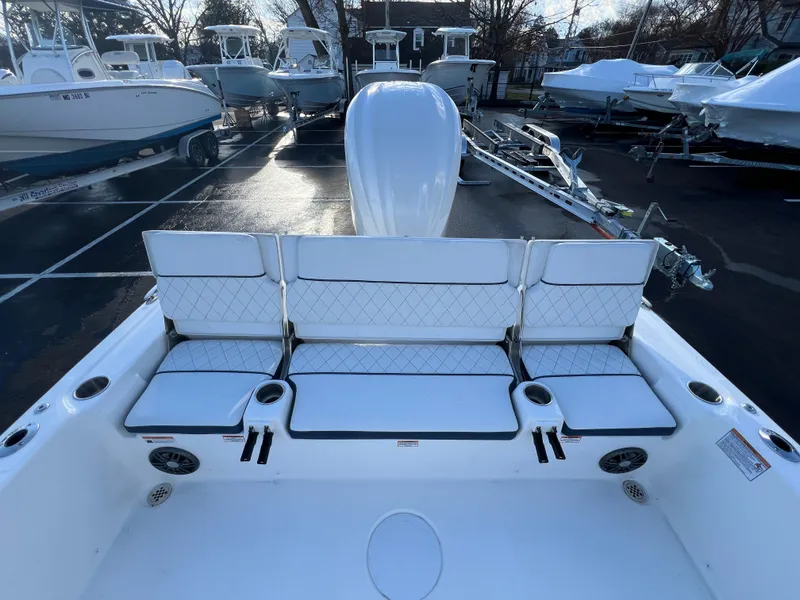 Slide: The Image of 2024 Sea Fox 251 Bay Fox boat interior with cushioned seating and cup holders. - 14