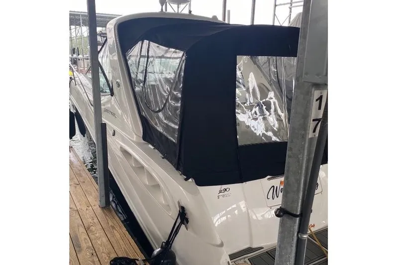 Slide: The Image of 2006 Sea Ray 290 Sundancer docked, featuring a black canvas cover. - 10