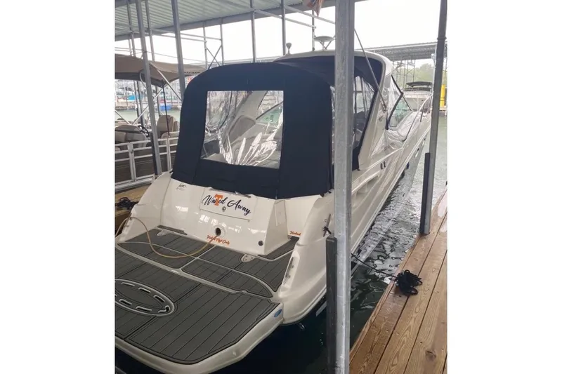 Slide: The Image of 2006 Sea Ray 290 Sundancer docked under a covered marina. - 11