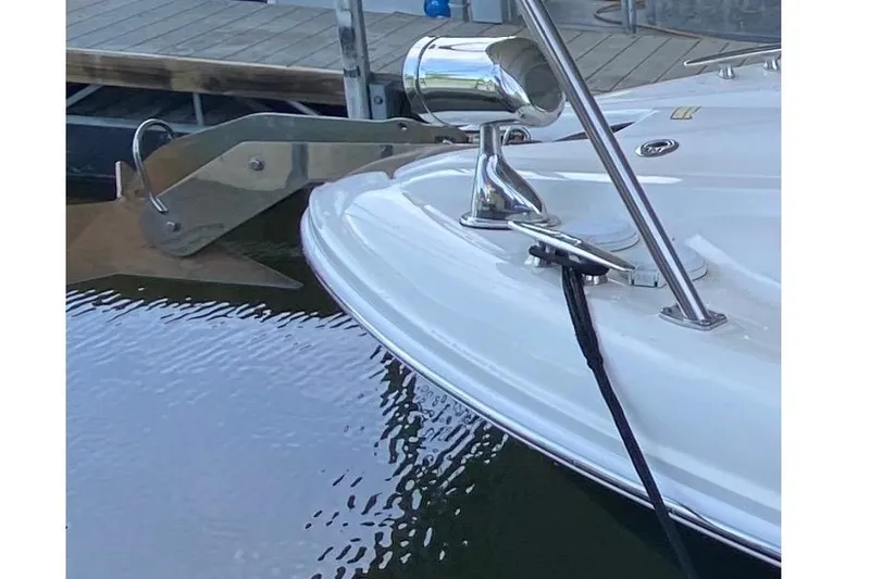 Slide: The Image of 2006 Sea Ray 290 Sundancer boat bow with anchor and docked at marina. - 14