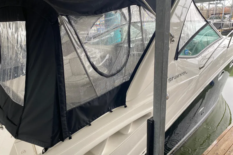 Slide: The Image of 2006 Sea Ray 290 Sundancer boat with black canopy docked in marina. - 16