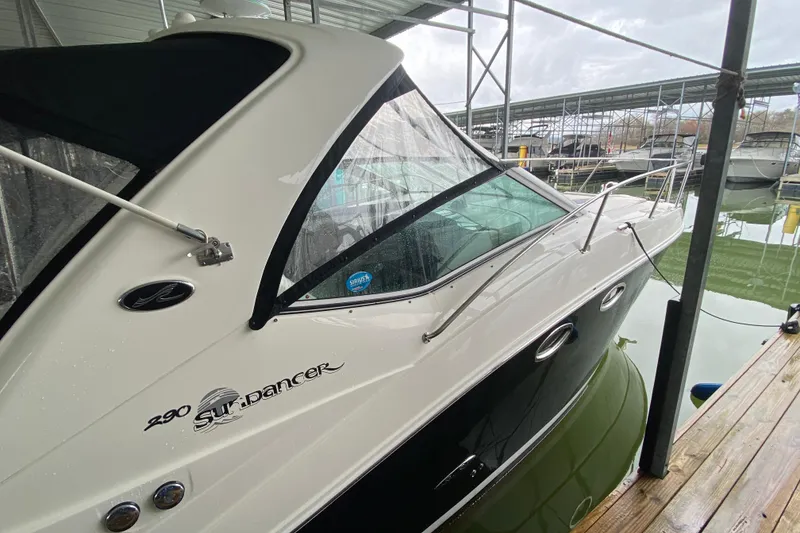 Slide: The Image of 2006 Sea Ray 290 Sundancer docked under a covered marina. - 17