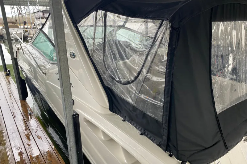 Slide: The Image of 2006 Sea Ray 290 Sundancer boat docked with black canopy cover. - 19