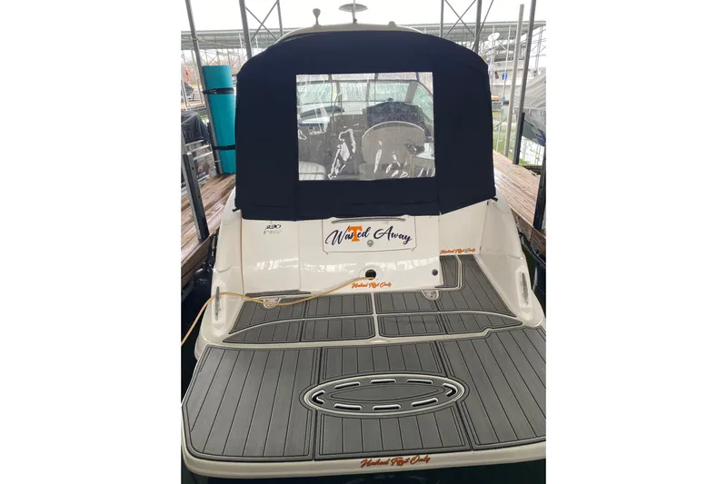 Slide: The Image of 2006 Sea Ray 290 Sundancer boat with covered cockpit, docked in marina. - 21