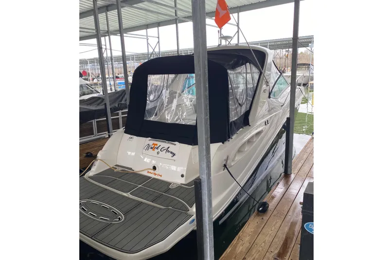 Slide: The Image of 2006 Sea Ray 290 Sundancer docked under a covered marina. - 22