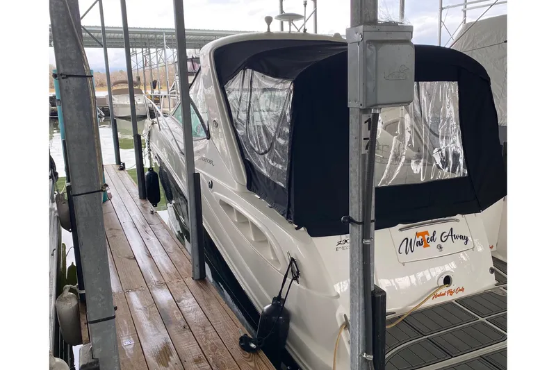 Slide: The Image of 2006 Sea Ray 290 Sundancer docked with black canopy in marina. - 23