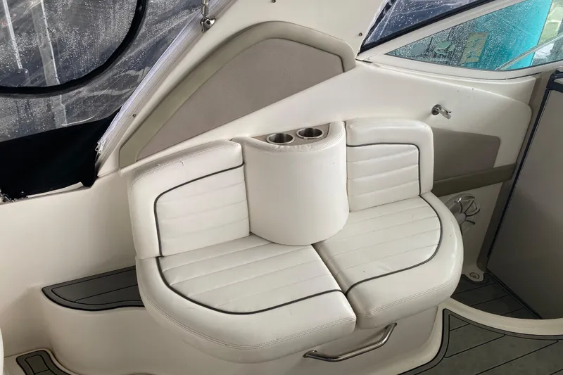 Slide: The Image of White leather seating on a 2006 Sea Ray 290 Sundancer boat with cup holders. - 26