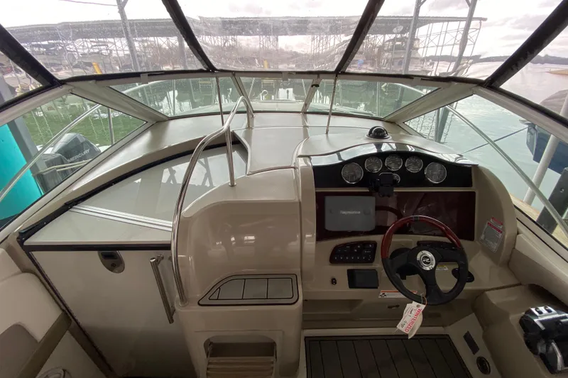 Slide: The Image of 2006 Sea Ray 290 Sundancer helm with steering wheel, gauges, and navigation system. - 29