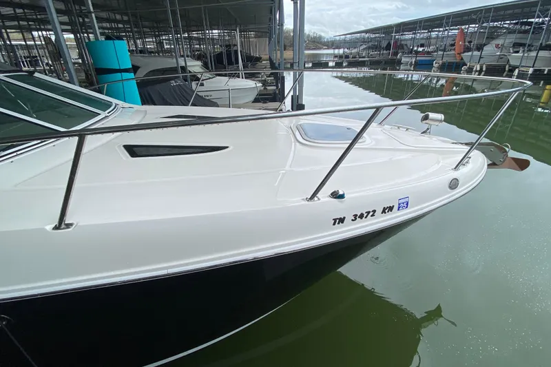 Slide: The Image of 2006 Sea Ray 290 Sundancer docked in a marina, showcasing sleek design and registration number. - 3
