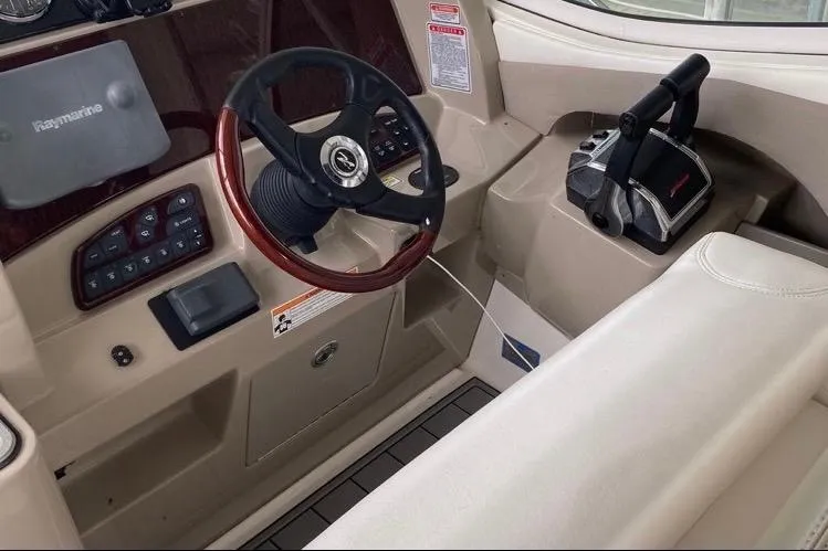 Slide: The Image of Interior helm of 2006 Sea Ray 290 Sundancer with steering wheel and controls. - 31