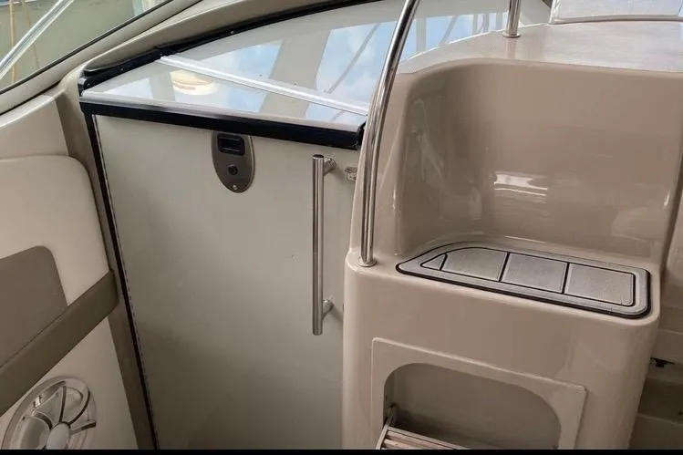 Slide: The Image of Interior view of a 2006 Sea Ray 290 Sundancer boat, featuring sleek design elements. - 32