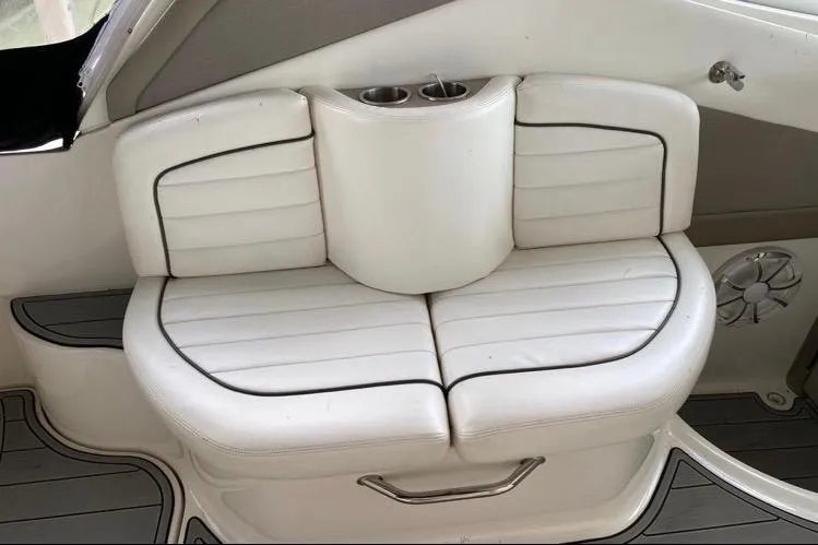 Slide: The Image of White leather seating on 2006 Sea Ray 290 Sundancer boat with cup holders. - 33