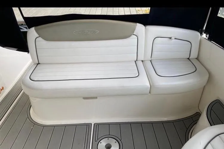 Slide: The Image of White seating area on 2006 Sea Ray 290 Sundancer boat, featuring sleek design and comfortable cushions. - 35