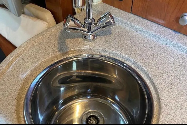 Slide: The Image of Stainless steel sink and faucet in 2006 Sea Ray 290 Sundancer boat interior. - 36