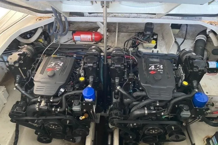 Slide: The Image of Twin engines of a 2006 Sea Ray 290 Sundancer boat, showcasing detailed mechanics. - 38