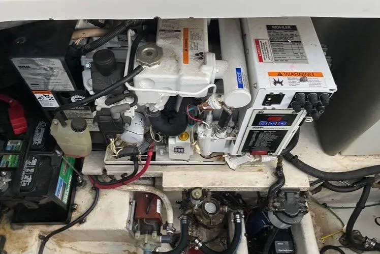 Slide: The Image of Engine compartment of a 2006 Sea Ray 290 Sundancer, featuring Kohler generator and battery setup. - 39