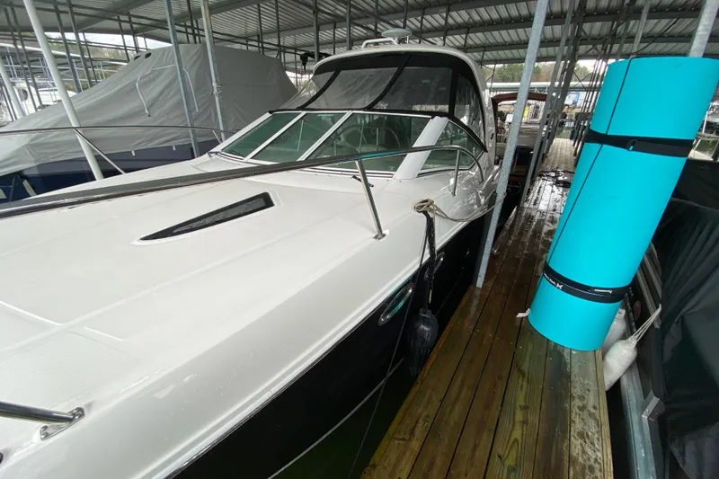 Slide: The Image of 2006 Sea Ray 290 Sundancer docked under covered marina. - 4