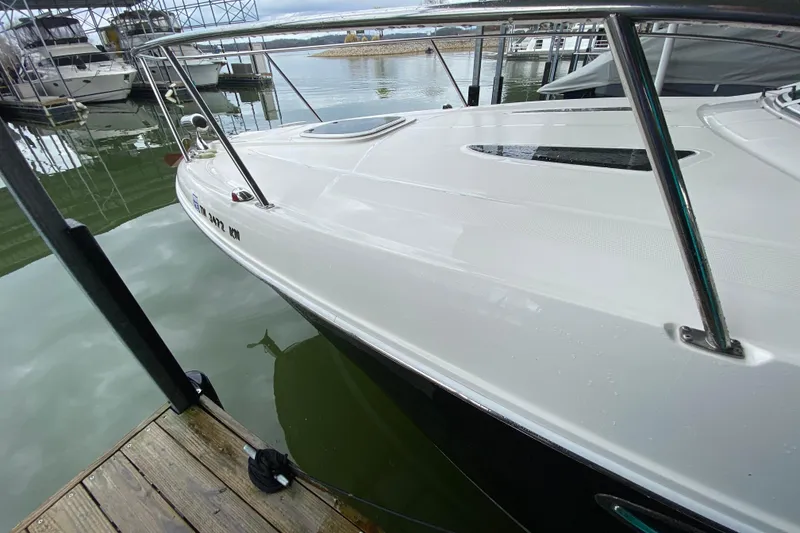 Slide: The Image of 2006 Sea Ray 290 Sundancer docked at marina, side view. - 5