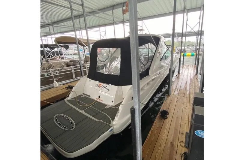 Slide: The Image of 2006 Sea Ray 290 Sundancer docked in a covered marina slip. - 7