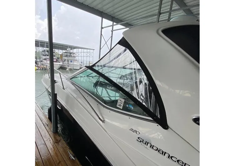 Slide: The Image of 2006 Sea Ray 290 Sundancer docked under a covered marina. - 9