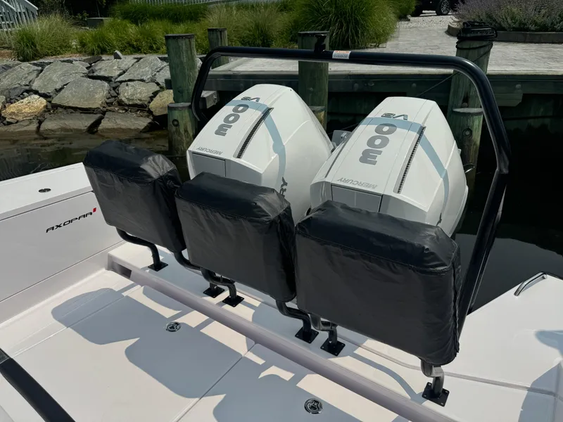 Slide: The Image of 2024 Axopar 37 Cross Cabin XC with dual outboard engines at dock. - 10