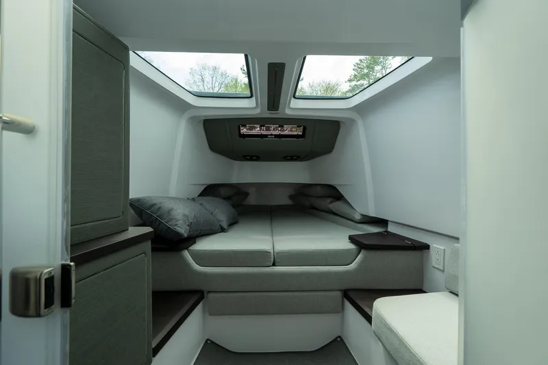 Slide: The Image of 2024 Axopar 37 Cross Cabin XC interior cabin with skylights and modern bedding. - 18