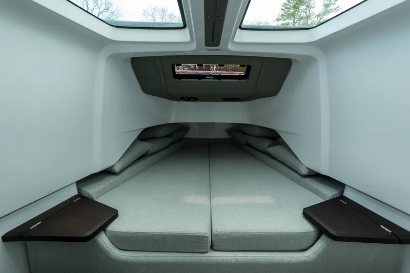 Slide: The Image of 2024 Axopar 37 Cross Cabin XC interior with modern sleeping area and skylights. - 19